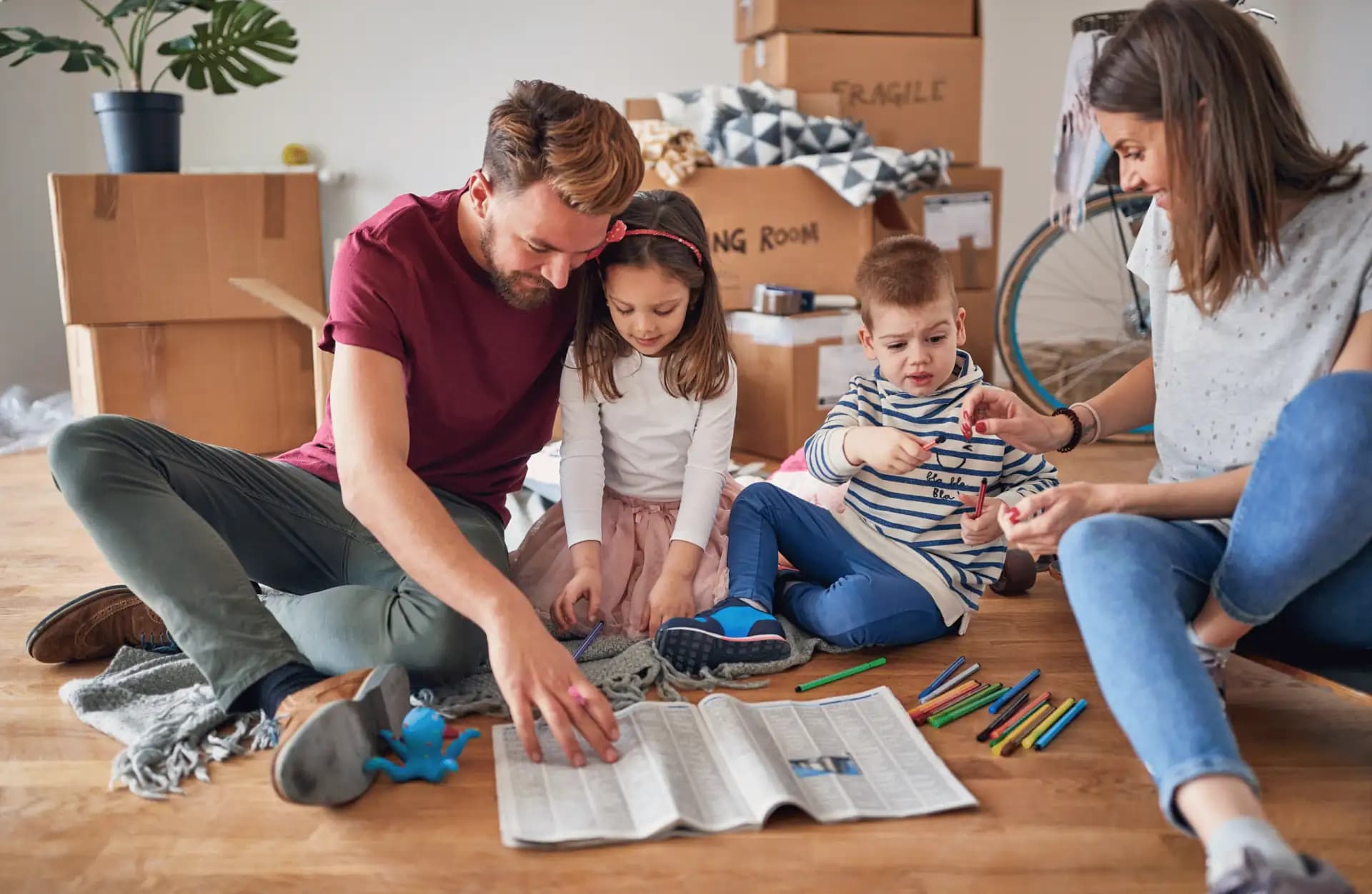 Family surrounded by moving boxes in a Los Angeles home